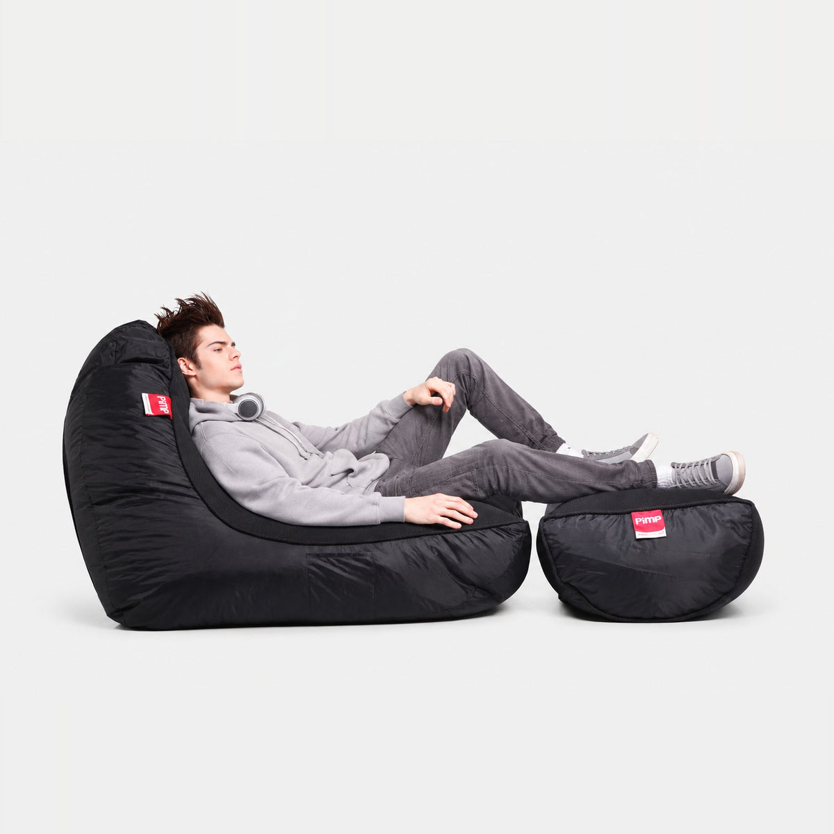 Black PIMP Blackout VIP beanbag sofa and ottoman with a reclining gamer
